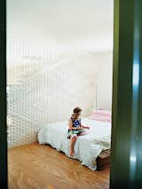 In the master bedroom, Flora sits in front of a clever divider Macleod created out of engineering felt.  Photo 3 of 15 in 14 Creative Ways to Design With Felt from Bellemo & Cat's Cradle