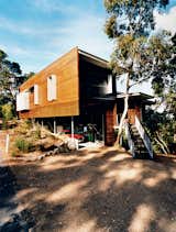 Batten screens of spotted gum wood sheath the house and allow ventilation into the outdoor storage area.