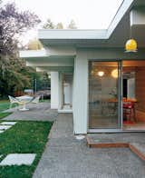 A Dokstra table from Ikea is situated on the patio.  Photo 9 of 15 in A Midcentury Modern Home in Southwest Portland
