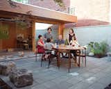 The main courtyard is a “communal” space, Tan says, and the couple keeps a second teak dining set at the ready for occasions when family or friends come for a meal.  Photo 15 of 17 in Following in Local “Laneway Housing” Tradition, Two Toronto Architects Craft Their Ideal Family Home