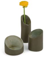 These cylindrical nesting vases are inspired by the shape of bamboo. Though made from ceramic, the surfaces have a roughness that evokes forests or jungles. They come as a set of three and can be stacked and used as a single vase, or separated and arranged as a trio. Made by hand in Brazil. 5 ½” h x 3 1/3” diam. $80.00  Photo 1 of 8 in Brazilian Design at the MoMA Store