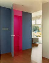 In the foyer, Deam left one surprise: The neon-pink guest bathroom is hidden behind heavy, dark-gray walls.