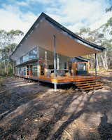 Solar panels mounted on a shipping container onsite (not pictured) heat this curvy house in Tasmania. The swooping roof cantilevered over the west-facing desk mitigates the intense afternoon sun.
