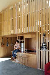 Kitchen, Wood, Wood, Concrete, and Wood Music is central to Andrew McKenzie’s living arrangements. With guitars hanging on his Gaboon plywood walls, he always has an instrument at hand.  Kitchen Concrete Wood Wood Photos from It's Musical in the Modern World
