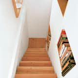 The stairway features built-in shelving that's accessible from both sides.
