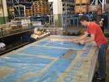 After choosing the tarp, each bag designer then sets out choosing which parts of the tarp he or she wants. Naturally they use as much of the tarp as they can before recycling the scraps, which go into making new truck tarps.