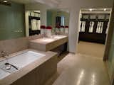 The bathrooms feature fossilized Brazilian limestone, Kohler fixtures, and Poliform closets.
