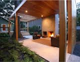 The outdoor living room features a fireplace inspired by Frank Lloyd Wright’s Usonian “heart of the home” hearth philosophy.