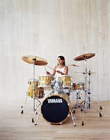 Berlin Jespersen, 8, daintily rocks the family drum kit, which Brent is also learning to play.