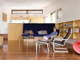 Hannah Ferguson relaxes in her living room. Her daughter Joanna prepares dinner in the open kitchen, behind and above the plywood banquette designed by the architects.  Photo 3 of 10 in Pedigree Charted