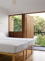 Ever the energetic grandmother, Ferguson insisted the house be flexible. In the three guest bedrooms,twin beds are mounted atop a railing system. Pushed together, they form a double bed. When Ferguson wants to accommodate a raft of children, she pushes the twin beds apart, thanks to the rails, with the flick of a finger.