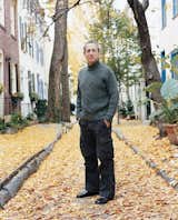 Ken Kalfus stands amidst the autumn leaves.