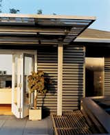Outdoor Day skinned the house in corrugated-aluminum siding, a tough industrial palette he picked up while designing airports. The corrugated stainless steel canopy was fabricated by Day’s former SCI-Arc classmates.  Photo 4 of 11 in Siding by Stephen Azevedo from Way Out West