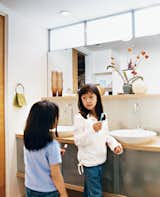 Kai and Téa brush their teeth in the upstairs bathroom shared by all. "We went with the 1950s thing—a family bathroom," explains Blatt. The sinks are by Kohler.