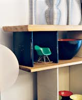 A miniature Eames rocker nestles in a Charlotte Perriand bookcase.