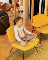 Clara strikes a yoga pose on a vintage Pierre Paulin chair for Artefort.