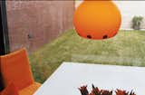 The pumpkin-orange Dordoni Halloween lamp is both UFO- and sun-like—a slightly humorous and cheering sight on a gray day in Holland. It was chosen, says Dedy, “simply because it says ‘welcome home.’”