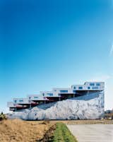 Completed in 2008, the Mountain Dwellings is the second of BIG’s three projects in Ørestad, a new neighborhood in Copenhagen where development is attracting many new inhabitants. The result does looks like a mountain—hence the building’s name and the inspiration for the mural of Mount Everest that adorns the 82-foot-high facade.