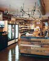 The market’s shelves are lined with all manner of Italian goodies, and the lighting grid on the ceiling, made of chain-link fence posts, is a nod to the grids common in Italian delis.