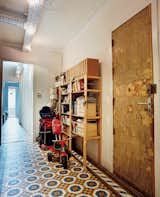 The front door hallway flooring features original turn-of-the-century floor tiles in this renovated first-floor apartment in Barcelona, Spain.