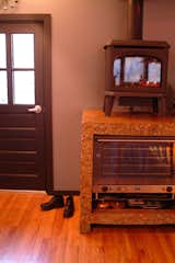 “In the mornings, people get up and hurry off to work, and then the house sits empty for the next seven or eight hours,” Moore says. “Instead of heating the whole house all day, we thought, ‘Why not pick key locations where people will be in the morning and put a stove there as an efficient heat source.” The spots they picked were the kitchen, living room, and children’s rooms. The residents can turn the stoves on for a short time with the click of a button. The heat is absorbed by the concrete and continues to radiate long after the stove is turned off.

Photo courtesy of Mike Moore/Tres Birds Workshop