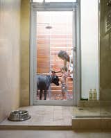 Outdoor and Shower Pools, Tubs, Shower A door in the master bathroom connects the indoor shower to an outdoor one. Here, Feldmann and the couple's three-year-old son, Eli, wash their dog Arnold--named by the previous owner after the local St. Arnold Brewing Company.  Photo 2 of 22 in The Shipping Muse