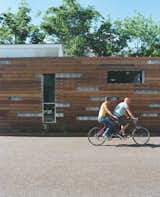 Exterior, House Building Type, Wood Siding Material, Metal Siding Material, and Shipping Container Building Type Alongside the redwood shade screen, which keeps the house from overheating, Freeman and Feldmann grow vegetables in an 18-inch-wide garden but frequently bike to nearby eateries for the local Mexican cuisine.  Photo 12 of 22 in The Shipping Muse