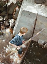 The young Meffans relish playing in the creek’s adjustable dam, made from poured concrete. The nutrient-rich silt that collects over the summer is dumped on the vegetable garden in the winter, when the creek flows freely.