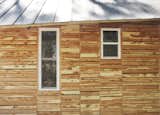 The students also attempted to appease residents by making their home "of the area." They based the design on vernacular shotgun houses and bought the cedar siding as off-cuts from a local lumberyard, which totaled $120.

Photo by 

Ty Cole  Photo 4 of 8 in By the Book