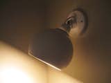 A small sconce lights the entry.  Photo 16 of 21 in Alvar Aalto in Lights by Sam Grawe