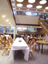 A view of the two-story dining hall and atrium. Students tend to gather in the lower level to eat, and the upper level to study.