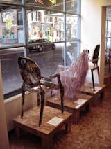 A trio of chairs on display in the window.