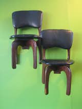Don Shoemaker's 1960s rosewood chairs from Mexico aren't too functional suspended on the wall, but they look beautiful against a lime green background. -Sarah
