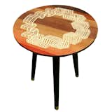The Windbreaker Table, with a hand-veneered design of seaside windbreakers situated in a circle formation.