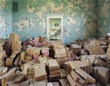 Crumbling paint serves as a proper backdrop to these boxes of files and state records at Spring Grove State Hospital in Cantonsville, Maryland.