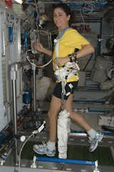 NASA astronaut Nicole Stott, Expedition 21 flight engineer, equipped with a bungee harness, exercises on the Combined Operational Load Bearing External Resistance Treadmill (COLBERT) in the Harmony node of the ISS. Photo taken October 20, 2009. 

Courtesy of NASA  Photo 6 of 25 in Life in Space: Email from the ISS by Miyoko Ohtake from Space Living: Astro Home