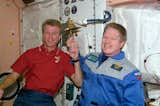 Astronauts Brent W. Jett, Jr. (left) and William M. Shepherd participate in an old Navy tradition of ringing a bell to announce the arrival or departure of someone to a ship. The bell is mounted on the wall in the Unity node of the ISS. The bell-ringing took place shortly after an in-space reunion on STS-97 Flight Day 9. Photo taken December 8, 2000. 

Courtesy of NASA