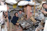 NASA astronaut Nicole Stott and Russian cosmonaut Roman Romanenko, both Expedition 20/21 flight engineers, are pictured at the galley in the Unity node of the ISS. Canadian Space Agency astronaut Robert Thirsk, Expedition 20/21 flight engineer, is mostly out of frame at right. Photo taken October 5, 2009. 

Courtesy of NASA