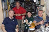 Canadian Space Agency astronaut Robert Thirsk (left), NASA astronauts Jeffrey Williams and Nicole Stott; along with Russian cosmonaut Maxim Suraev, all Expedition 21 flight engineers, share a meal at the galley in the Zvezda Service Module of the ISS. Photo taken October 12, 2009. 

Courtesy of NASA