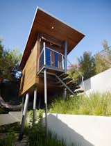 Exterior, Treehouse, and Cabin Metaphorically, architect Chris Kempel said, the Kynar-painted steel columns are trees.  “It was like taking a box and poking it with chopsticks.”  Exterior Cabin Treehouse Photos from An Atypical Tree House