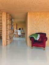 Cubic bookshelves do double duty as a dividing wall and as a sliding door.