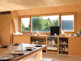 In his kitchen built on the cheap, Barache installed appliances donated by a few archi-

tectural Good Samaritans. “I don’t even remember where the sink is from,” he says. Two built-in sliding-door cabinets house the kitchen basics, and the custom-built dining set, a modern riff on the farmers’ table and benches, is large enough to welcome family and visitors dropping in for a meal.  Photo 8 of 11 in Modern Wooden A-Frame Retreat in France