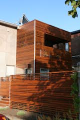 The architect used horizontal slats for privacy, but alternated them on the fence and second-floor deck to allow sunlight and breezes through. Solar panels atop the roof heat the water; a green roof is in the process of growing in. The project was awarded Green Renovation of the Year and Best Housing Detail at the 2009 Ottawa Housing Design Awards.