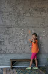 The couple’s daughter, Kalyna, puts her own spin on her father’s engravings, which he calls a "concrete coloring book." Dedicating this side of the building to the earth, he carved herds of caribou into the panels. The abstract marks at the base skirt the entire exterior and were added for a consistent design element.