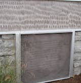 Instead of removing the old coal chute, Griffin printed the original deed to the property on a new concrete panel covering it.  Photo 16 of 17 in Engraved House
