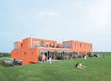 This eye-catching villa in the Netherlands, designed by Next Architects, proves that you can go big and go home as well. While some homes feature hints of color, the Villa van Vijven structure garners well-deserved attention thanks to its warm orange facade that is meant to mimic the tiled rooftops of Holland’s country buildings. The orange of the exterior also carries over into the communal entrance beneath the building, offset by natural elements such as stones adjacent to the entryway.