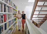 Bob Krone and Paula Van Dijk pose in front of their built-in bookcase. They live in the red unit.