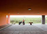Outdoor chores like gardening and landscaping fall to the residents. The entryway's orange glow is magnificent when lit by the sun.  Photo 22 of 22 in Modern Communal Living in the Netherlands