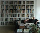Architect Peter Eisenman reclines at home surrounded by his massive library.