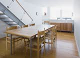 In the dining room, furniture by Wegner and local designers Speke Klein blends with the white oak floors and stair.